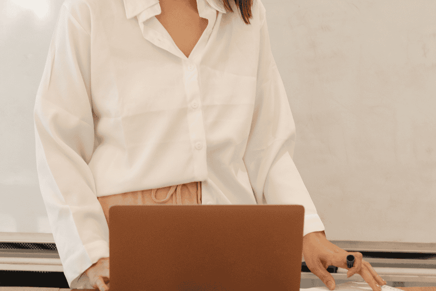 Person standing at a computer, looking focused, illustrating the impact of productivity addiction on work-life balance.