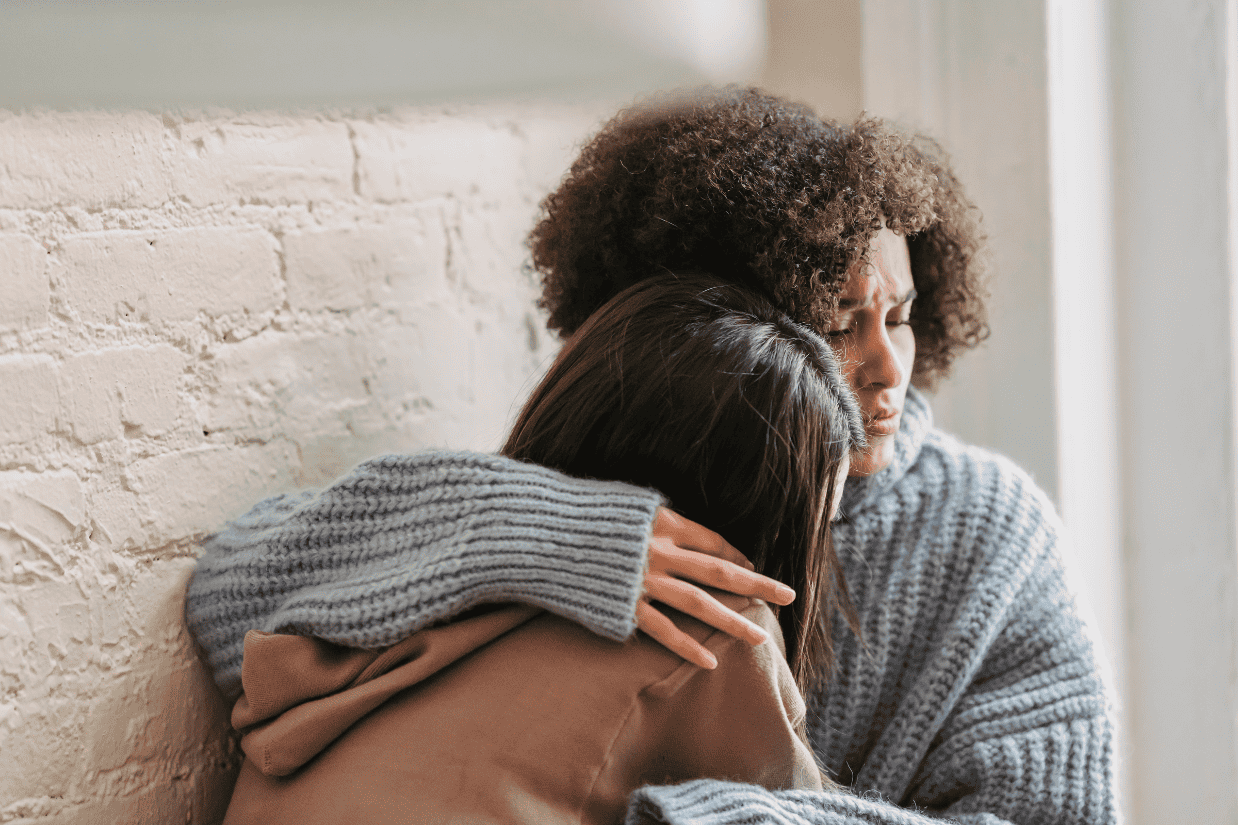 One person offering support to another, symbolizing the importance of asking for help when needed.