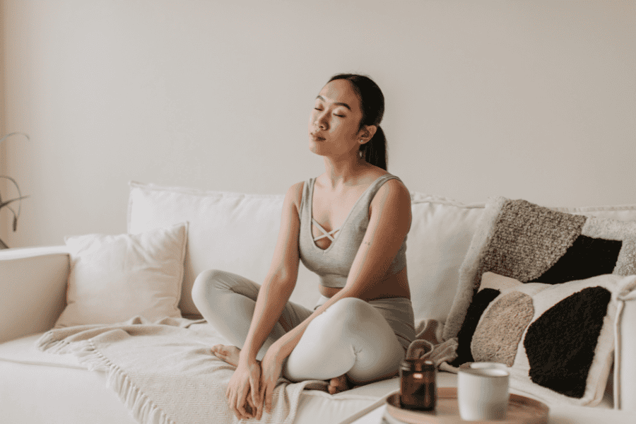 Peaceful self-care moment to cope with anxiety triggers through meditation and relaxation at home.