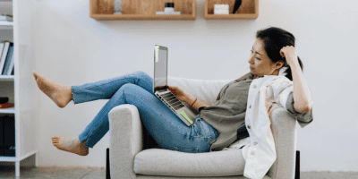 Young professional overwhelmed by toxic hustle culture while working remotely from home.