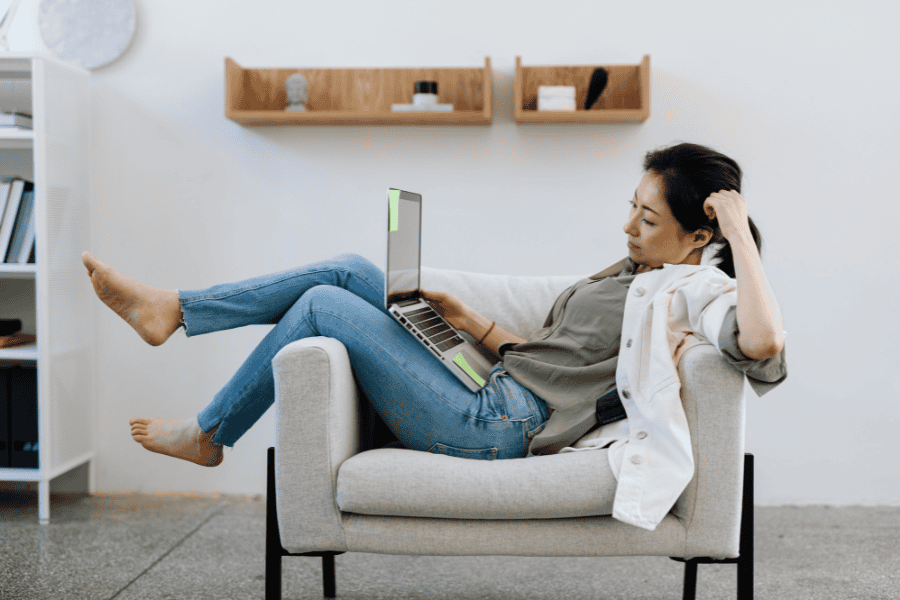 Young professional overwhelmed by toxic hustle culture while working remotely from home.