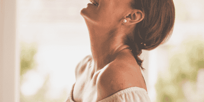 Confident woman smiling and enjoying the moment—capturing what it looks like to explore how to feel good enough in everyday life.