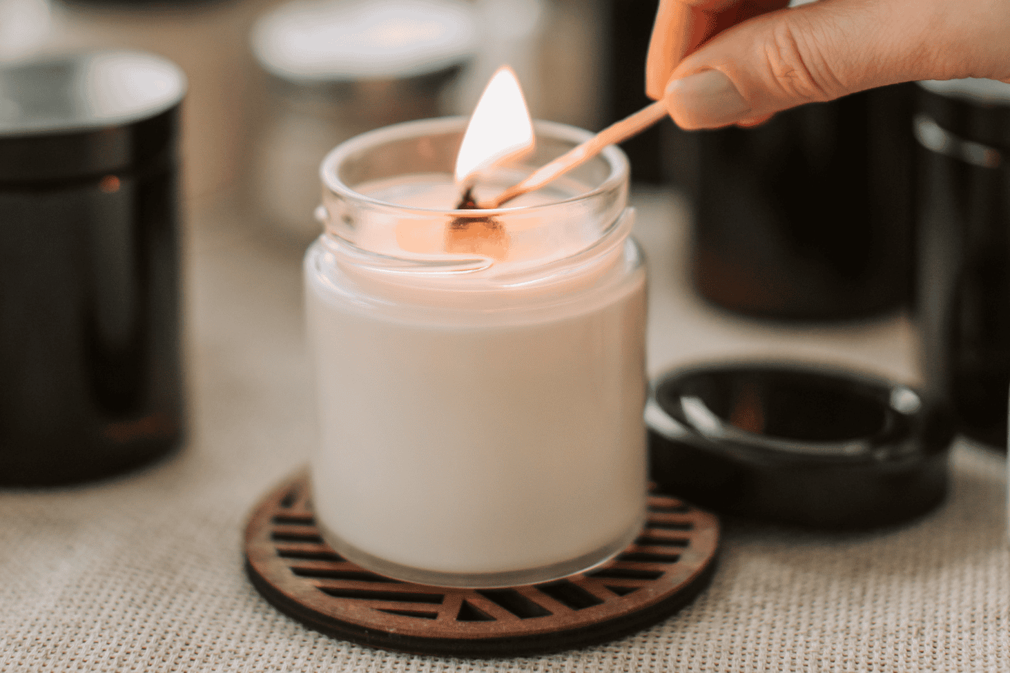 White candle being lit with a match, representing mindful time management strategies for creating balance in daily routines.
