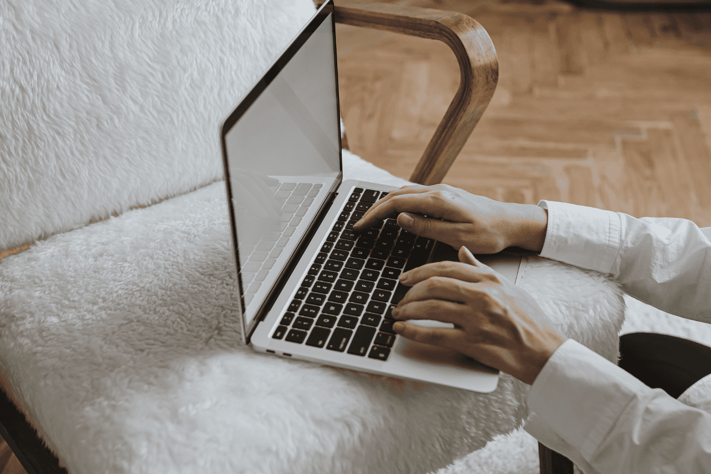 Close-up of hands typing on laptop, illustrating how to avoid decision fatigue by working with focus and intention.